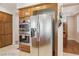Kitchen with wood cabinets and stainless steel refrigerator and double ovens at 613 Pinnacle Heights Ln, Las Vegas, NV 89144