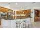 Eat-in kitchen featuring granite countertops, stainless steel appliances and wood cabinets at 613 Pinnacle Heights Ln, Las Vegas, NV 89144