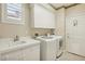 Bright laundry room with a utility sink, countertop, washer, and dryer at 613 Pinnacle Heights Ln, Las Vegas, NV 89144