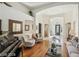 Elegant living room with wood floors, piano, and comfortable seating arrangement at 613 Pinnacle Heights Ln, Las Vegas, NV 89144