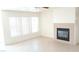 Bright living room featuring tile floors, a fireplace, and several windows allowing for natural light at 6449 Elizabethtown Ave, Las Vegas, NV 89110
