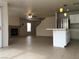 Open-concept living area with a fireplace and tile flooring, seamlessly connecting the kitchen and living spaces at 6449 Elizabethtown Ave, Las Vegas, NV 89110