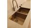 Close-up of a stainless steel double bowl kitchen sink with modern faucet and white quartz countertop at 6449 Elizabethtown Ave, Las Vegas, NV 89110