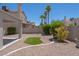 Exterior view of backyard with stone ground cover, plants and artificial grass at 6601 W Pepperidge Way, Las Vegas, NV 89108