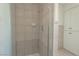 Bathroom featuring tiled shower and built in storage with black hardware at 6601 W Pepperidge Way, Las Vegas, NV 89108