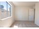 Bright bedroom featuring plush carpet, neutral walls, and a large window at 6601 W Pepperidge Way, Las Vegas, NV 89108