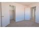 Bright carpeted bedroom with an open closet and a doorway leading to other rooms at 6601 W Pepperidge Way, Las Vegas, NV 89108