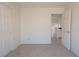 Carpeted bedroom with closet space and a doorway leading to the hallway at 6601 W Pepperidge Way, Las Vegas, NV 89108