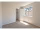 Well-lit bedroom with neutral carpet, window, closet, and neutral walls at 6601 W Pepperidge Way, Las Vegas, NV 89108