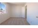 Cozy bedroom with neutral carpet, ample natural light, and a view of the outdoors at 6601 W Pepperidge Way, Las Vegas, NV 89108