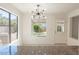 Bright dining area with an elegant light fixture and backyard views at 6601 W Pepperidge Way, Las Vegas, NV 89108