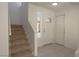 The entryway of this home features a staircase, tiled floors, and a front door with glass accents at 6601 W Pepperidge Way, Las Vegas, NV 89108
