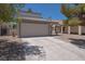 Inviting exterior with a two-car garage, desert landscaping, and a welcoming driveway at 6601 W Pepperidge Way, Las Vegas, NV 89108