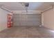 Spacious garage with a neutral color scheme and ample room for parking and storage at 6601 W Pepperidge Way, Las Vegas, NV 89108