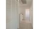 Neutral hallway featuring tile floors, white walls, storage closet, and recessed lighting at 6601 W Pepperidge Way, Las Vegas, NV 89108
