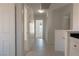 Hallway with neutral tile flooring, recessed lighting, and white walls connecting rooms at 6601 W Pepperidge Way, Las Vegas, NV 89108