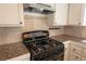 Close up of the kitchen featuring granite countertops, a gas range, and tiled backsplash at 6601 W Pepperidge Way, Las Vegas, NV 89108