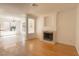 Bright living room featuring a fireplace, decorative lighting, and access to the kitchen at 6601 W Pepperidge Way, Las Vegas, NV 89108