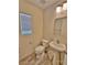 Cozy half bathroom with a pedestal sink, toilet, and modern fixtures at 6621 Churnet Valley Ave, Las Vegas, NV 89139