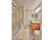 Well-lit bathroom featuring a shower-tub combo, a towel, and a vanity with double mirrors at 6621 Churnet Valley Ave, Las Vegas, NV 89139