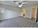 Spacious bedroom featuring plush carpet, a ceiling fan, and access to an en suite bathroom at 6621 Churnet Valley Ave, Las Vegas, NV 89139