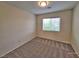 Cozy carpeted bedroom with a bright window that allows ample natural light at 6621 Churnet Valley Ave, Las Vegas, NV 89139