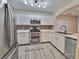 Bright kitchen featuring stainless steel appliances, white cabinets, and a modern backsplash at 6621 Churnet Valley Ave, Las Vegas, NV 89139