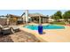 Inviting backyard featuring a refreshing pool, barbecue area, and an outdoor living space at 7404 Wittig Ave, Las Vegas, NV 89131