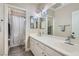 Bright bathroom with double sinks, a large mirror, and shower-tub combination at 7404 Wittig Ave, Las Vegas, NV 89131