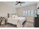 Cozy bedroom with neutral decor, plush carpet, ceiling fan and shuttered window at 7404 Wittig Ave, Las Vegas, NV 89131