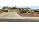 Inviting home features a two-car garage, desert landscaping, and solar panels on the roof at 7404 Wittig Ave, Las Vegas, NV 89131