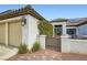 View of a home's entry gate and covered front patio sitting area with a tile roof at 7404 Wittig Ave, Las Vegas, NV 89131