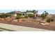 The attractive front yard is xeriscaped with desert vegetation, rocks, and stacked stone accents at 7404 Wittig Ave, Las Vegas, NV 89131