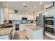 Modern kitchen featuring stainless steel appliances, granite countertops, and a central island at 7404 Wittig Ave, Las Vegas, NV 89131
