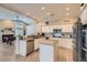 Bright kitchen with stainless appliances, granite counters, island, and open view to living area at 7404 Wittig Ave, Las Vegas, NV 89131