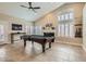 Inviting living room with vaulted ceiling, fireplace and pool table for entertaining guests at 7404 Wittig Ave, Las Vegas, NV 89131