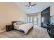 Comfortable main bedroom featuring a fireplace, plush carpeting, ceiling fan and lots of natural light at 7404 Wittig Ave, Las Vegas, NV 89131