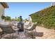 Relaxing patio with a modern fireplace, surrounded by climbing plants on the stucco wall at 7404 Wittig Ave, Las Vegas, NV 89131