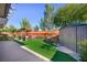 Backyard features a storage shed, seating area with awning, artificial turf, and partial perimeter wall at 10042 Pipestone St, Las Vegas, NV 89141
