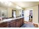 Bathroom with double vanity and a door leading to the walk-in closet at 10042 Pipestone St, Las Vegas, NV 89141