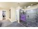 Bathroom featuring a walk-in shower with marble and dark tile at 10042 Pipestone St, Las Vegas, NV 89141
