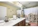 Bathroom with a double sink vanity and shower-tub combination at 10042 Pipestone St, Las Vegas, NV 89141