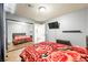 Bedroom with mirrored closet, hardwood floors, queen bed and a mounted TV at 10042 Pipestone St, Las Vegas, NV 89141
