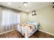 Cozy bedroom featuring hardwood floors and a comfortable-looking bed and neutral paint at 10042 Pipestone St, Las Vegas, NV 89141