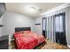 Bedroom with hardwood floors, queen size bed and a TV at 10042 Pipestone St, Las Vegas, NV 89141