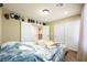 Bright bedroom featuring hardwood floors, dual closets, and slider doors with a warm neutral color scheme at 10042 Pipestone St, Las Vegas, NV 89141