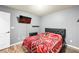 Bedroom with hardwood floors, queen size bed and a mounted TV at 10042 Pipestone St, Las Vegas, NV 89141
