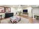 Open bonus room with a wall mounted TV, carpet, and access to other areas of the home at 10042 Pipestone St, Las Vegas, NV 89141