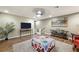 Spacious bonus room with a wall-mounted TV, plants, and a decorative coffee table at 10042 Pipestone St, Las Vegas, NV 89141