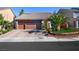 Charming single-story home featuring desert landscaping and a spacious two-car garage with a brick-paved driveway at 10042 Pipestone St, Las Vegas, NV 89141